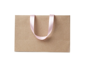 Photo of Paper shopping bag with ribbon handles on white background. Mockup for design