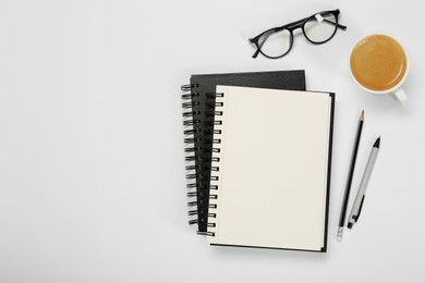 Photo of Flat lay composition with notebooks and coffee on white table