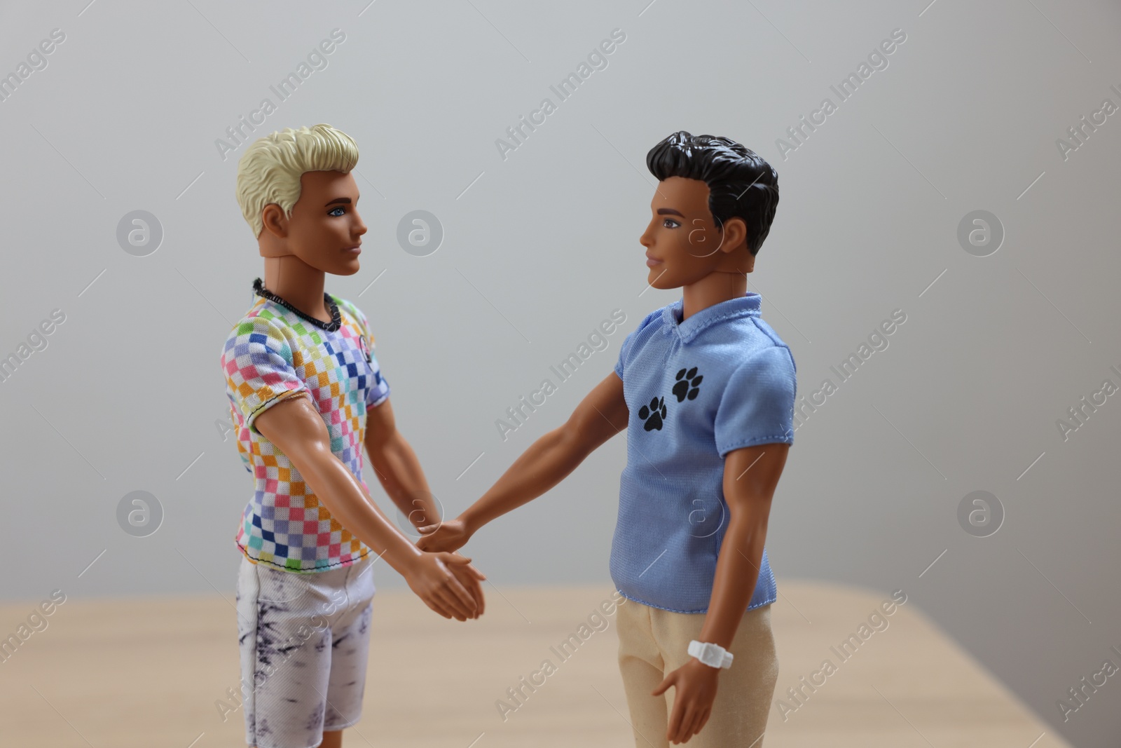 Photo of Leiden, Netherlands - September 20, 2023: Stylish Ken dolls handshaking on blurred background