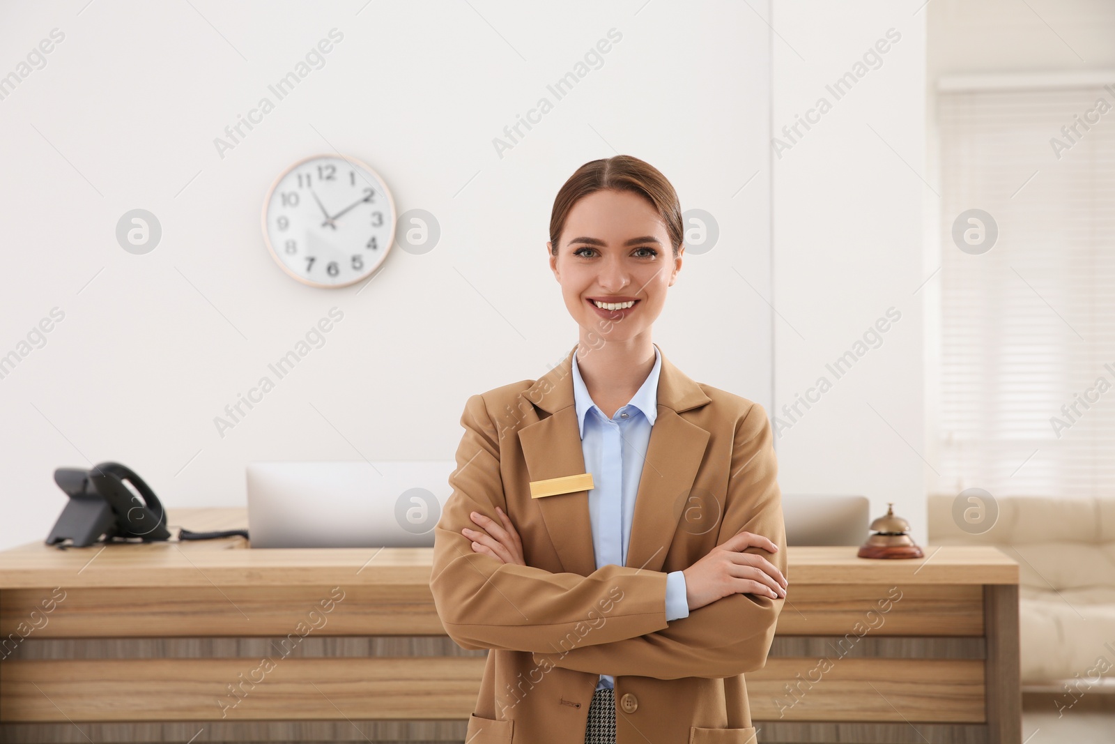 Photo of Portrait of beautiful receptionist near counter in hotel