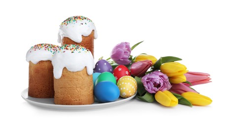 Traditional Easter cakes, tulips and colorful eggs on white background