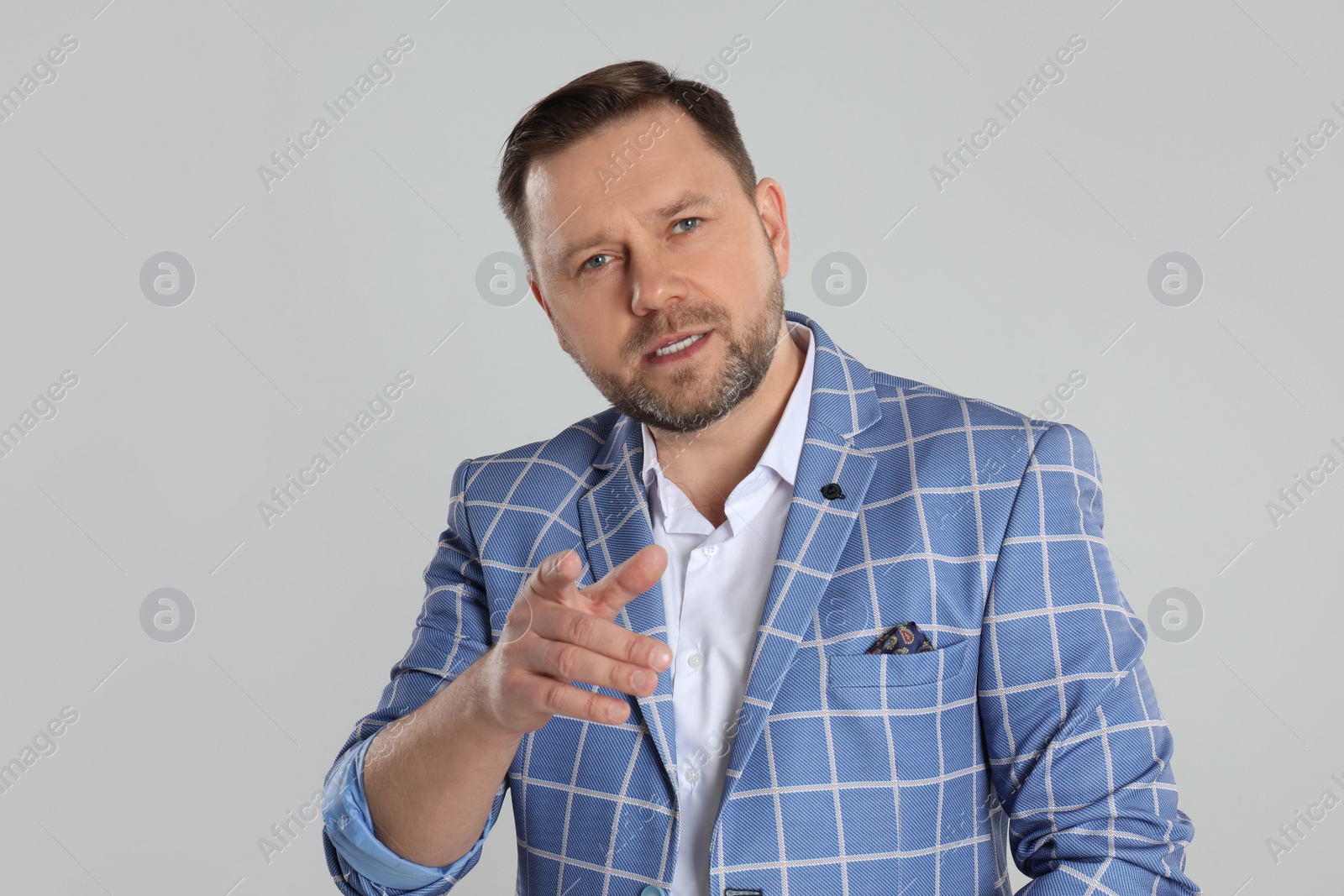 Photo of Portrait of emotional mature man on light grey background