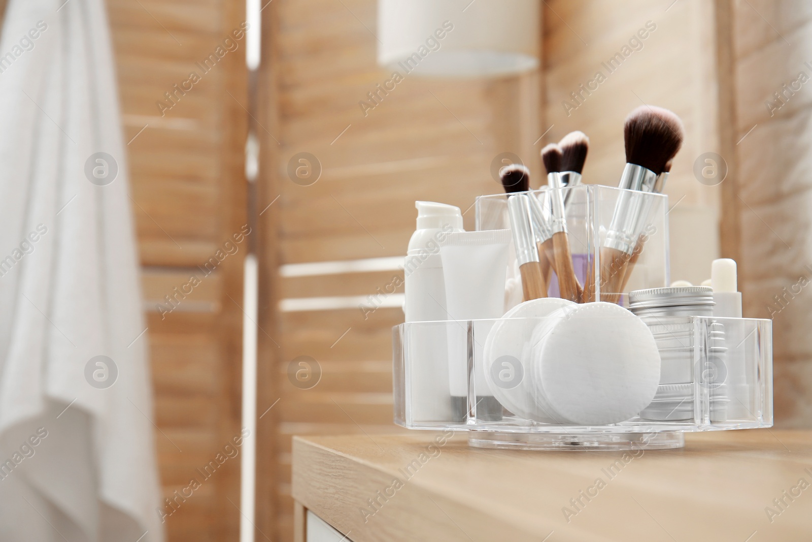 Photo of Organizer with cosmetic products and space for text on dressing table