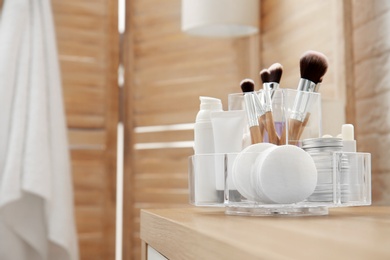 Photo of Organizer with cosmetic products and space for text on dressing table