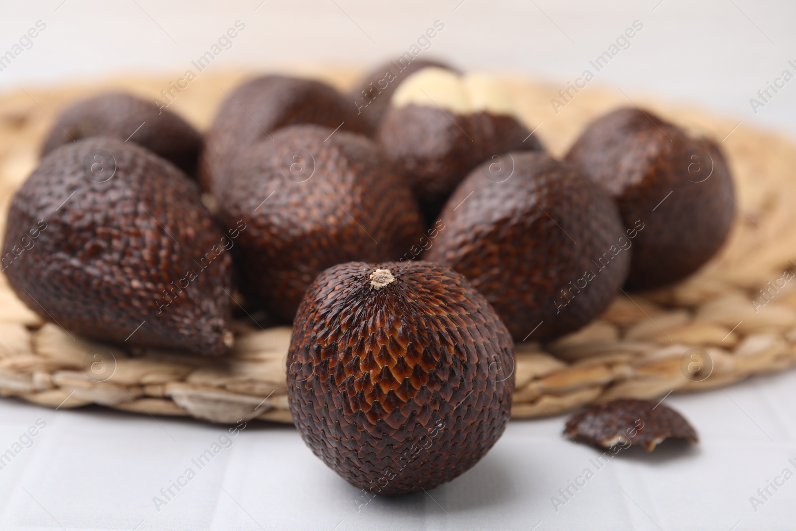 Photo of Many fresh salak fruits on white table, closeup