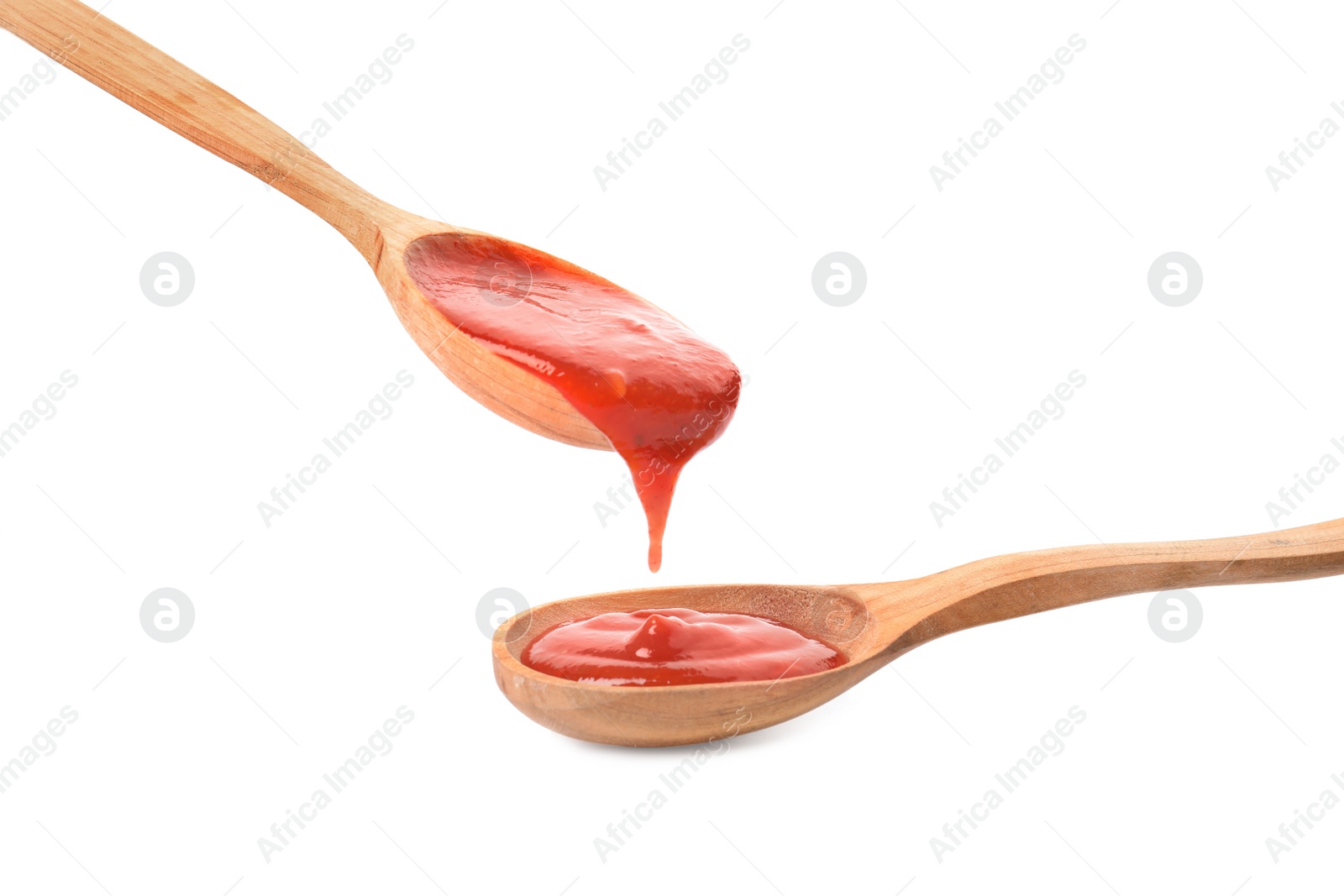 Photo of Spoons of tomato sauce isolated on white