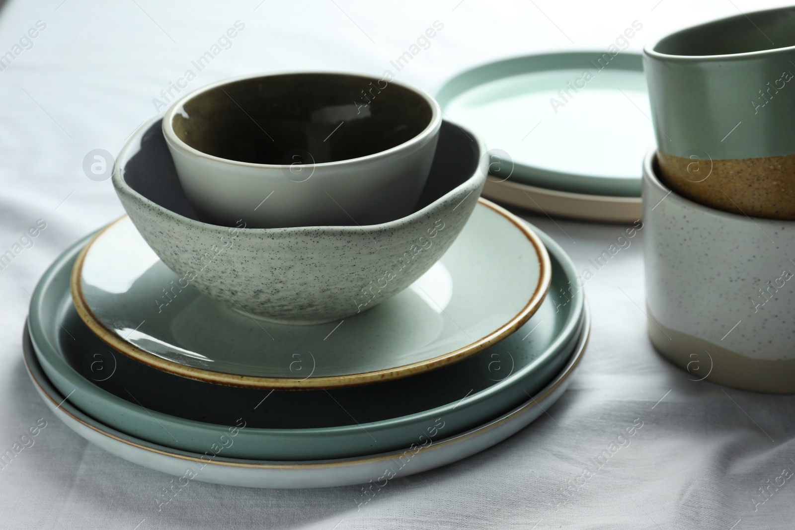 Photo of Stacked stylish empty dishware on table, closeup