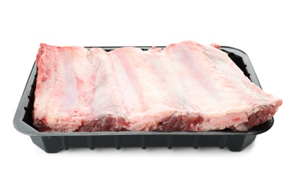 Photo of Plastic container with raw ribs on white background. Fresh meat