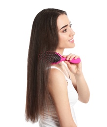 Photo of Beautiful young woman with hair brush on white background