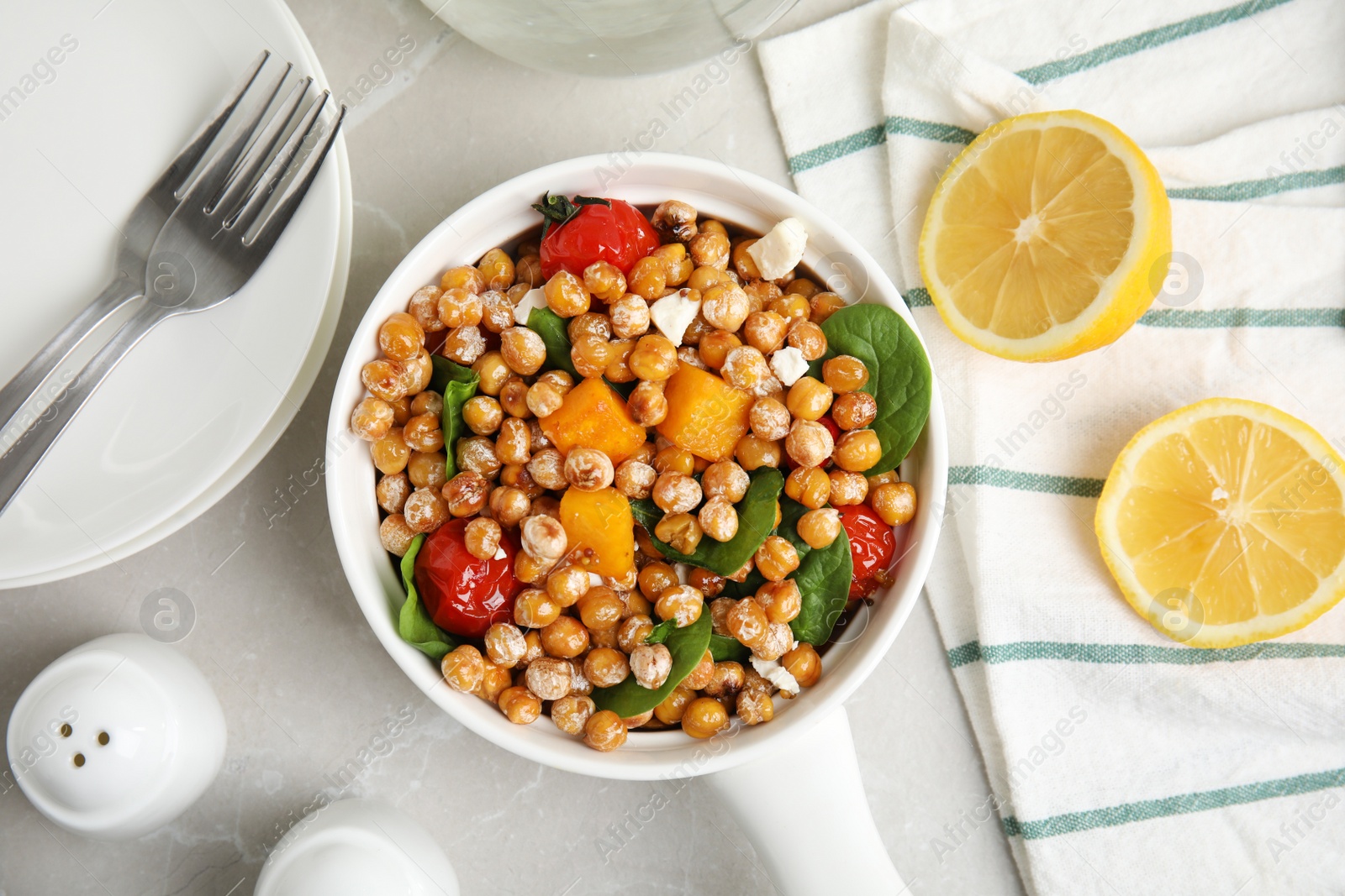 Photo of Delicious fresh chickpea salad served on light grey marble table, flat lay