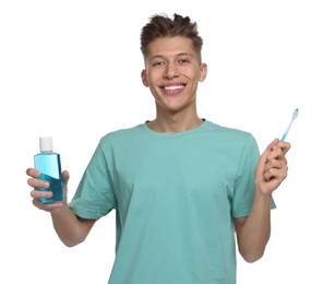 Young man with mouthwash and toothbrush on white background