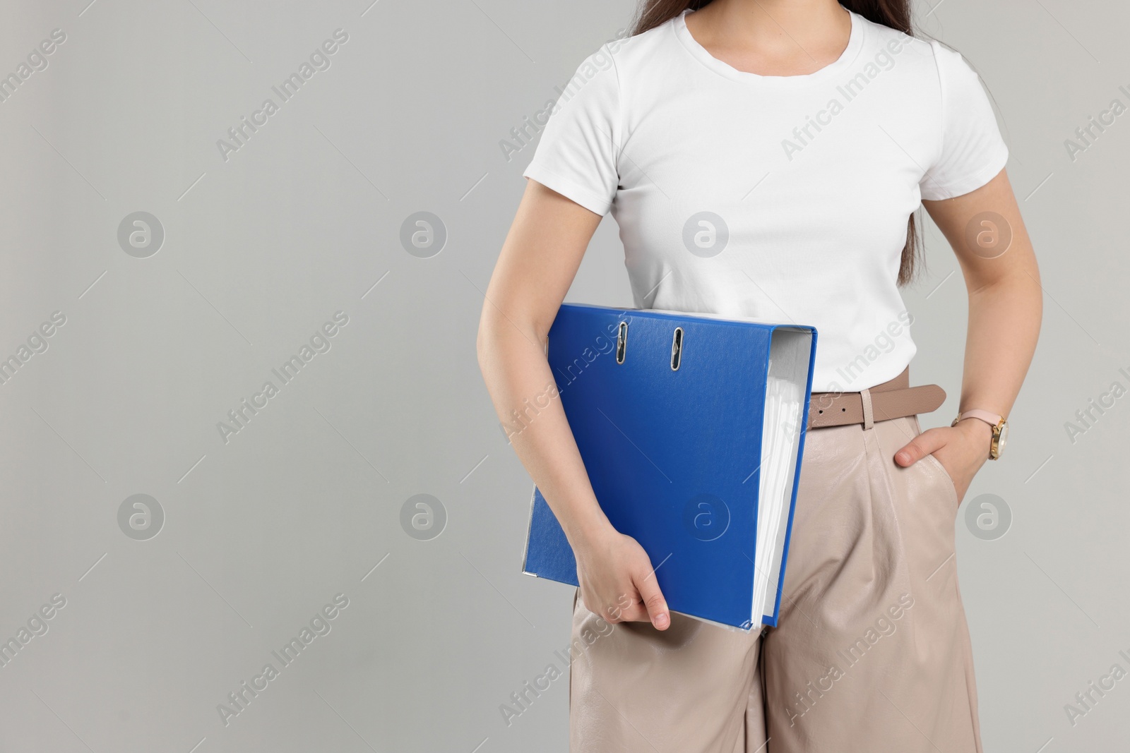 Photo of Woman with folder on light gray background, closeup. Space for text