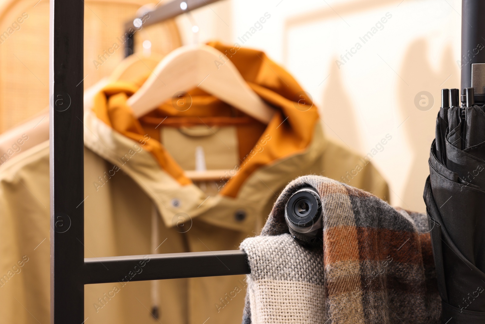 Photo of Camera hidden under scarf in wardrobe closet. Space for text