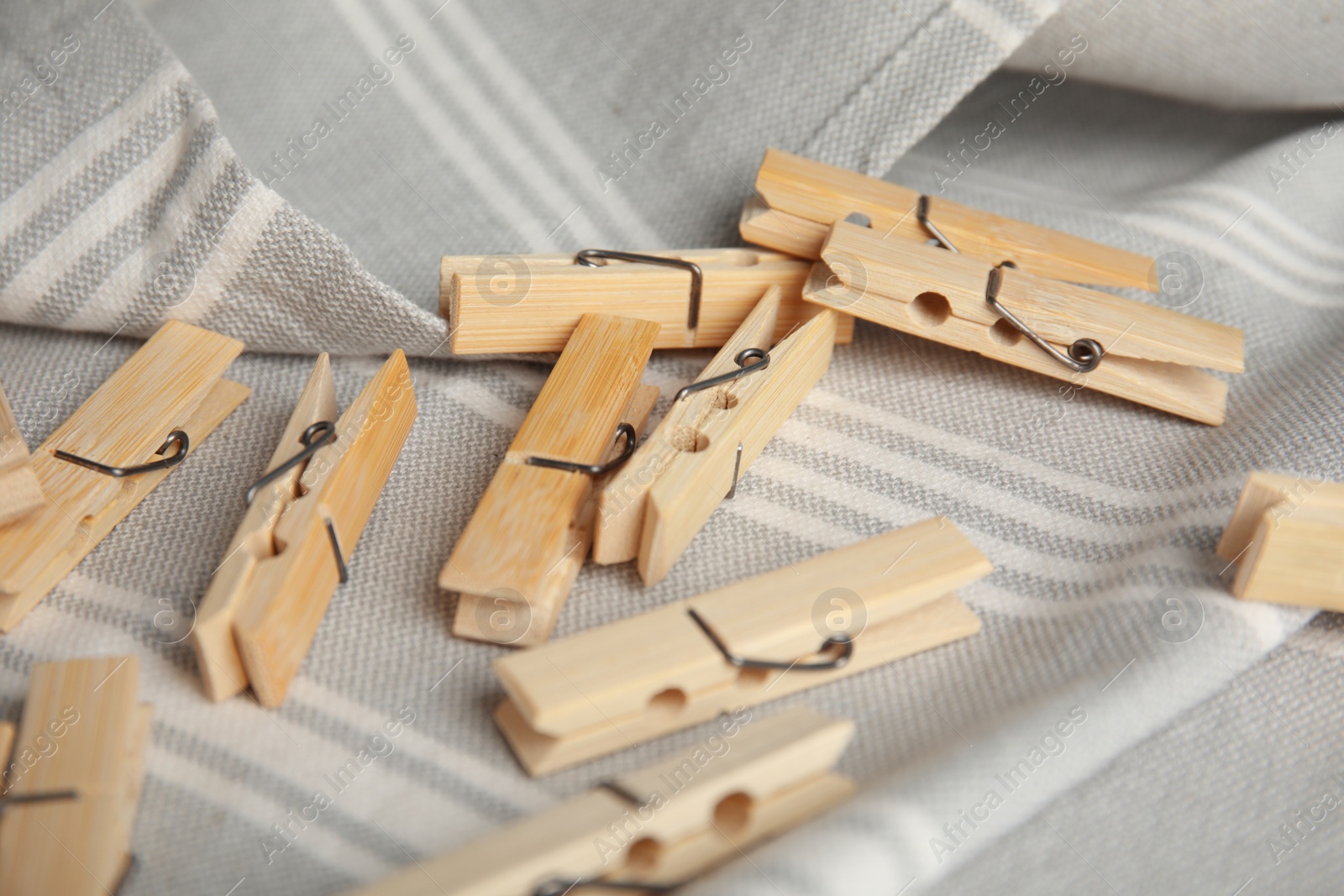 Photo of Many wooden clothespins on light grey towel