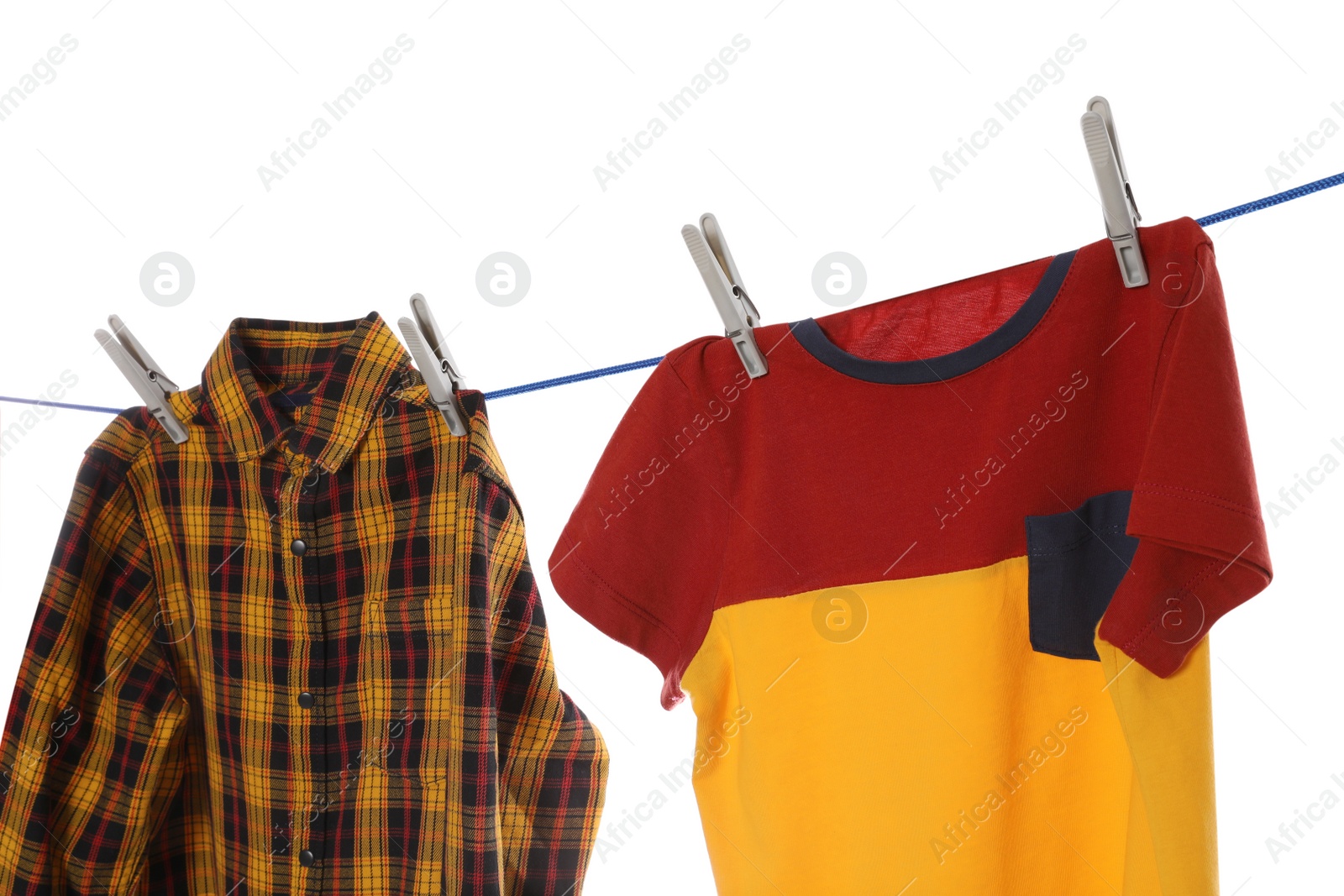 Photo of Bright clothes drying on washing line against white background