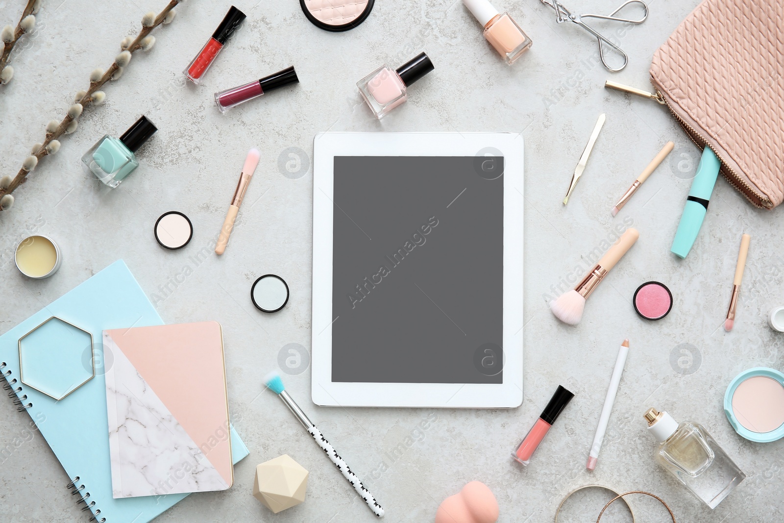 Photo of Flat lay composition with tablet and makeup products on grey background