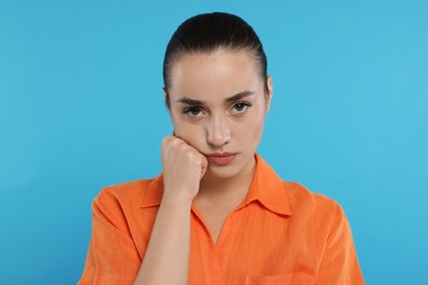 Photo of Portrait of resentful woman on light blue background