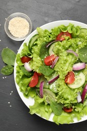 Delicious salad in bowl on grey table, flat lay