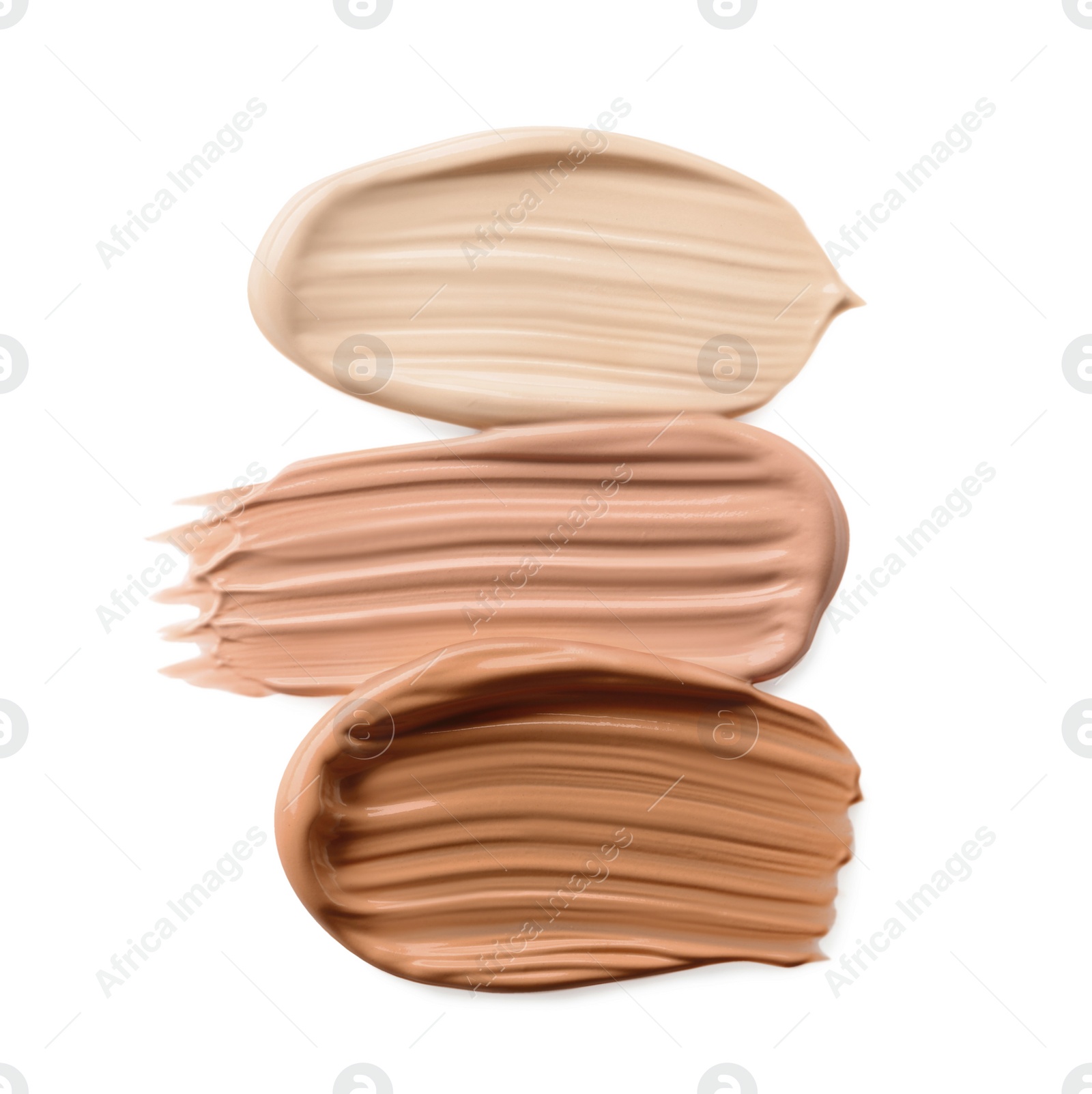 Image of Different shades of liquid foundation on white background, top view