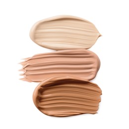 Image of Different shades of liquid foundation on white background, top view