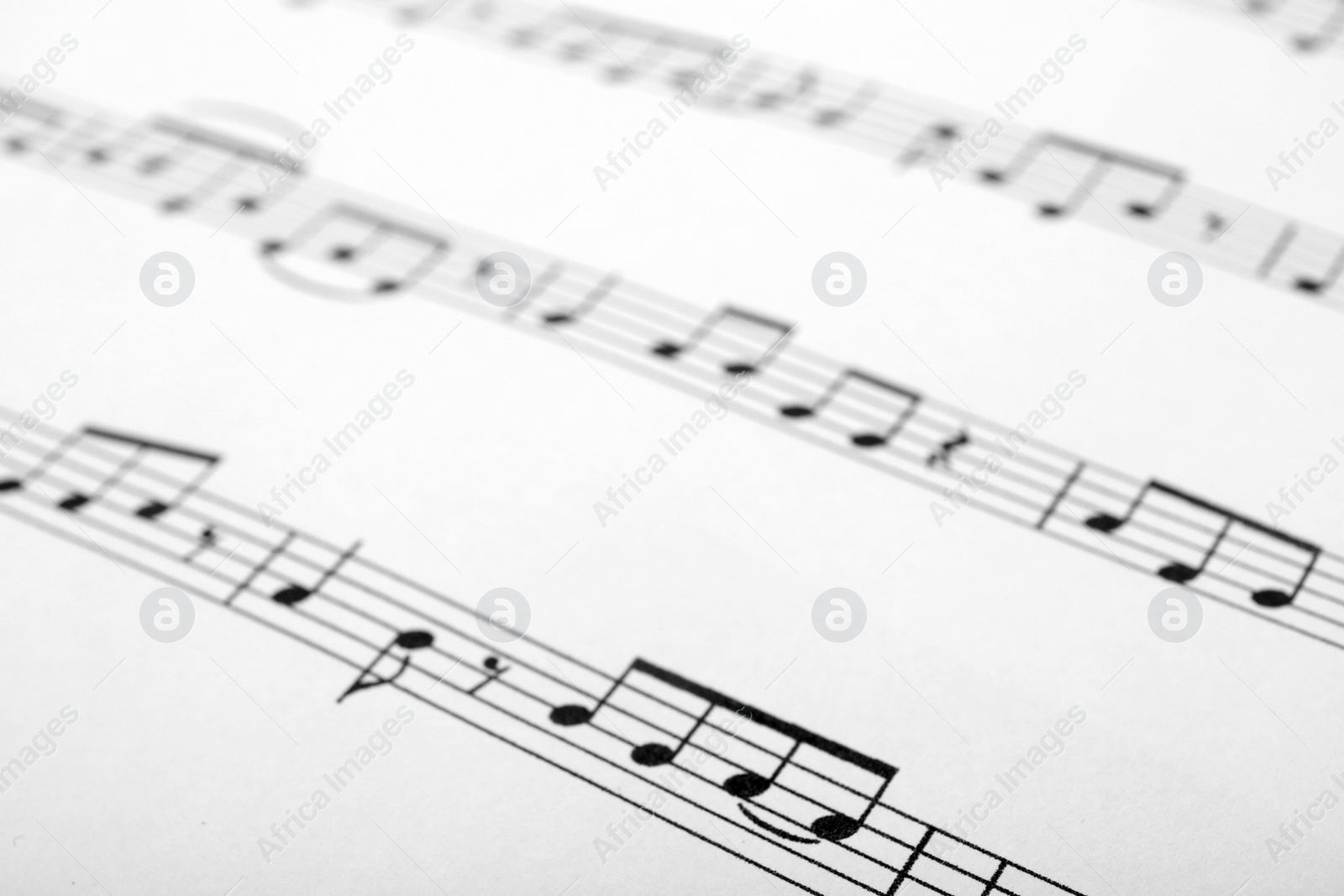 Photo of Sheet with music notes as background, closeup