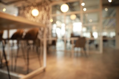 Photo of Blurred view of beautiful modern cafe interior