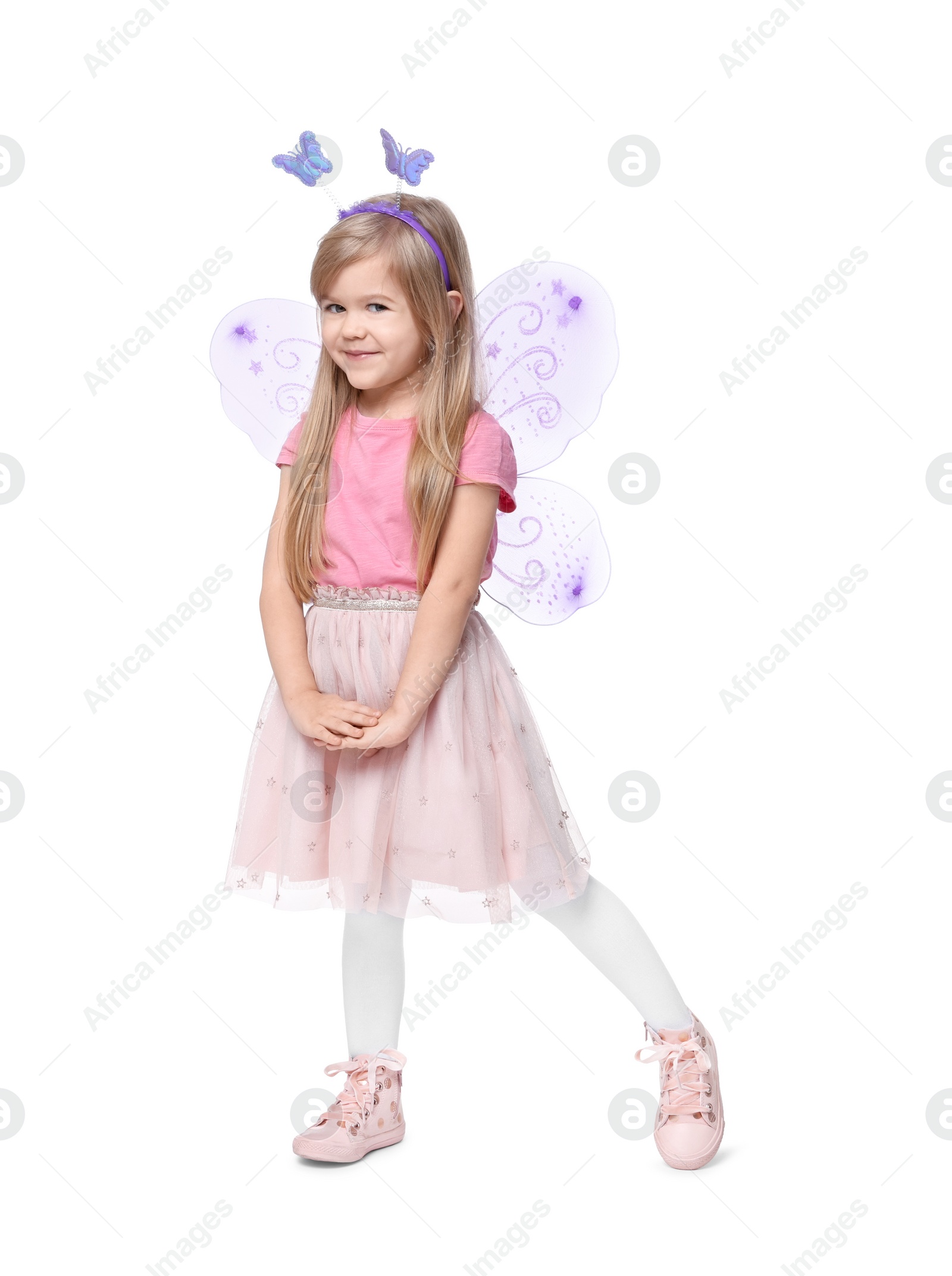 Photo of Cute little girl in fairy costume with violet wings on white background