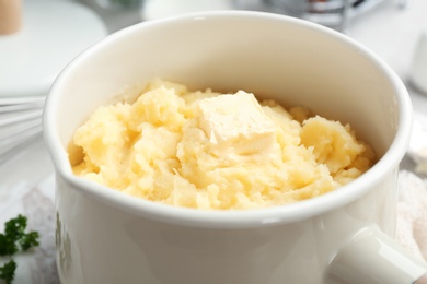 Photo of Saucepan with tasty mashed potato on table, closeup