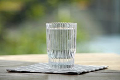 Glass of pure water on wooden table