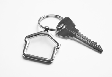 House key with trinket on white background