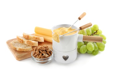 Photo of Pot of tasty cheese fondue and products isolated on white