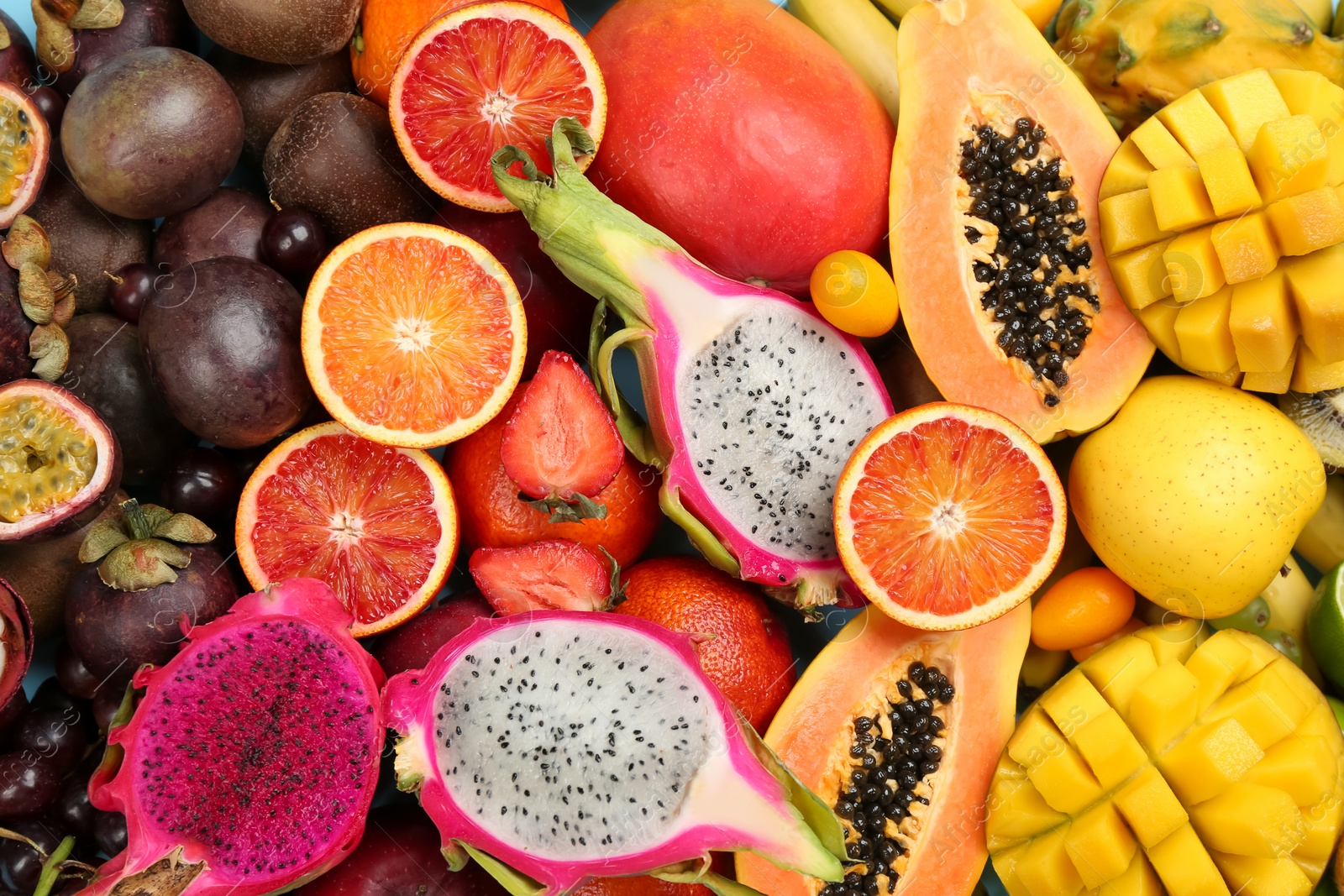 Photo of Many different delicious exotic fruits as background, top view