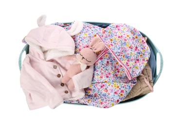 Laundry basket with baby clothes and crochet toy isolated on white, top view