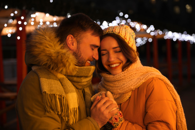 Happy couple spending time at Christmas fair