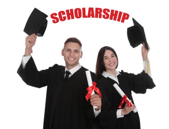 Image of Scholarship concept. Happy students in academic dresses with diplomas on white background