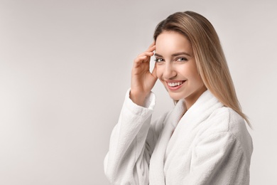 Photo of Beautiful young woman with silky skin on light background