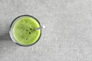 Photo of Glass with delicious detox juice on light background, top view