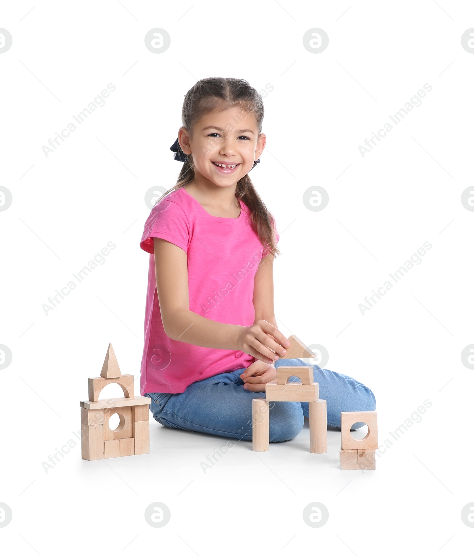 Photo of Cute child playing with wooden blocks on white background