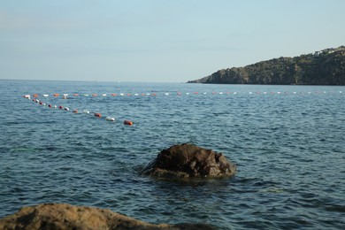 Photo of Picturesque sea, stones and shore under blue sky
