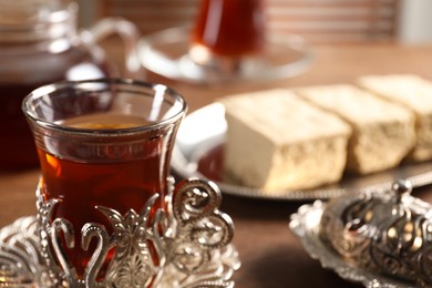 Glass of traditional Turkish tea in vintage holder on table, closeup. Space for text