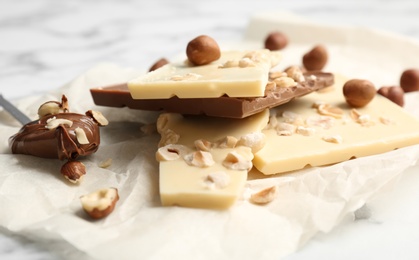 Photo of Delicious milk and white chocolate bars on table