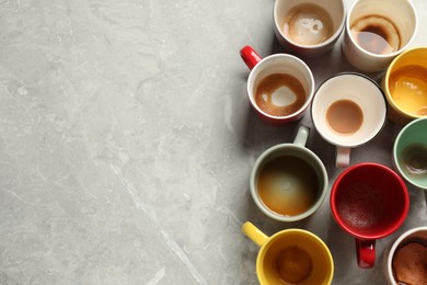 Photo of Many dirty cups after different coffee drinks on light grey marble table, flat lay. Space for text