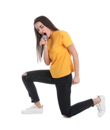 Young woman wearing casual clothes singing in microphone on white background