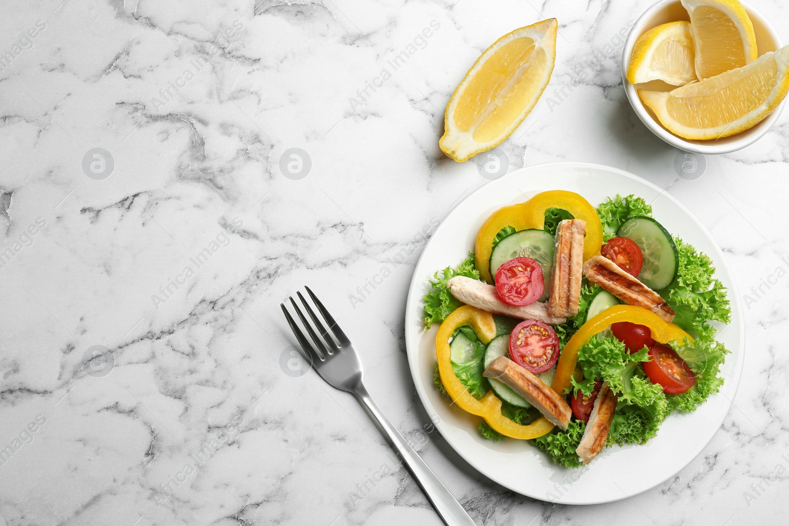 Photo of Delicious fresh chicken salad served on white marble table, flat lay. Space for text