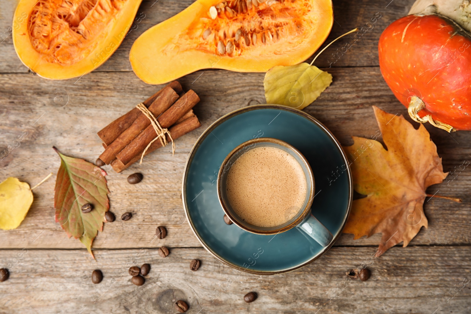 Photo of Flat lay composition with pumpkin spice latte in cup on wooden background