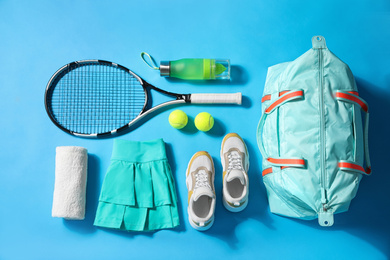Photo of Flat lay composition with sports bag on light blue background