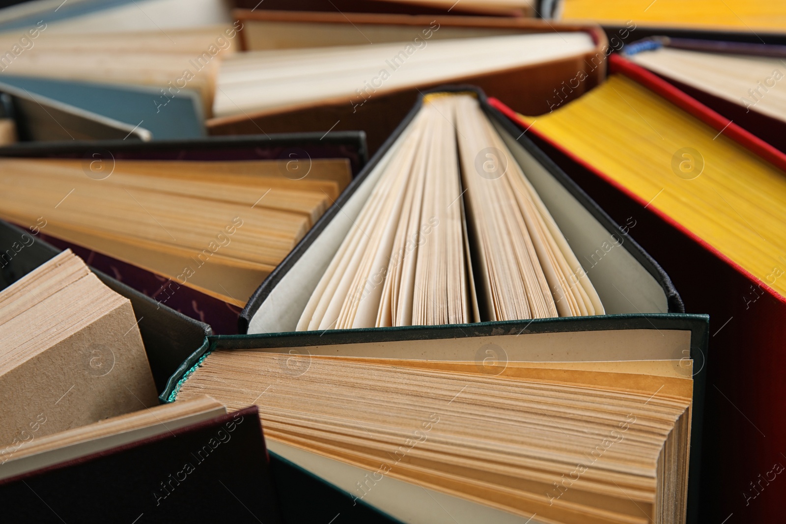 Photo of Stack of hardcover books as background, closeup