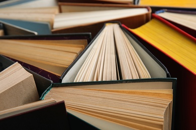 Photo of Stack of hardcover books as background, closeup