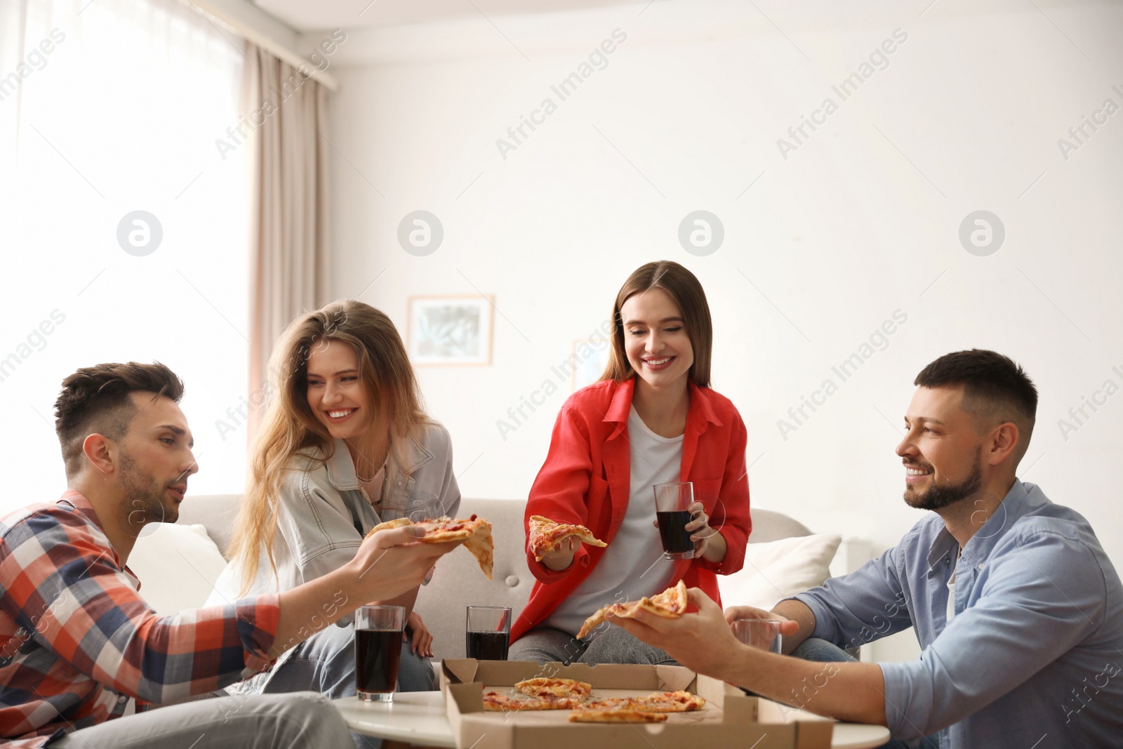 Photo of Group of friends eating tasty pizza at home