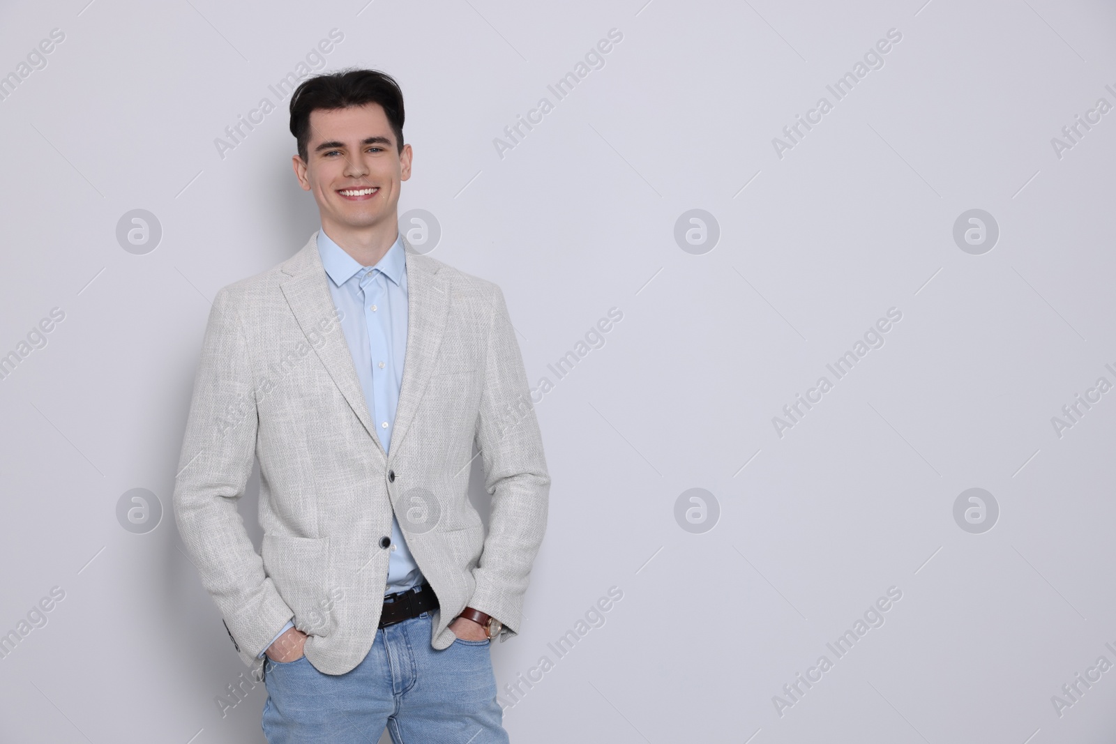 Photo of Portrait of happy young man on white background, space for text